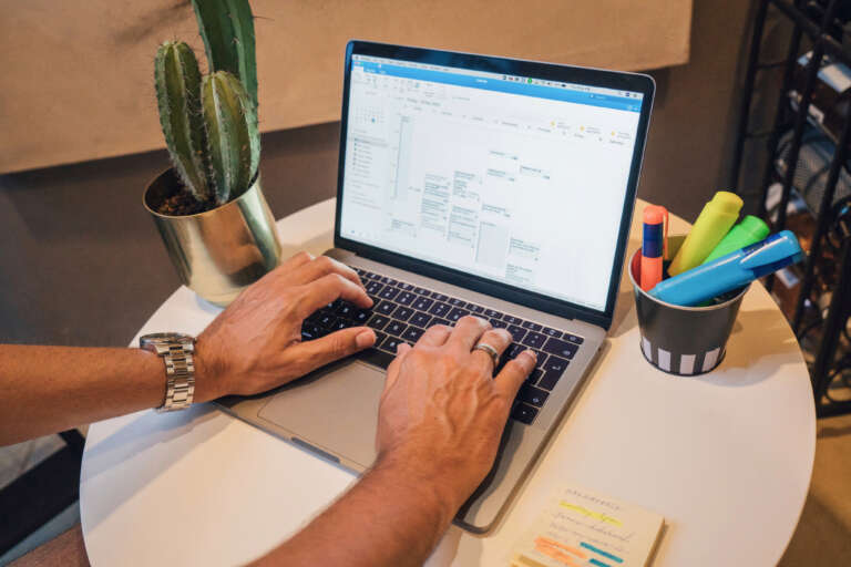 A person planning social media content on a laptop