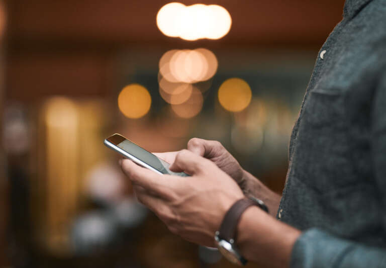 A close-up of a person on their phone with a message notification